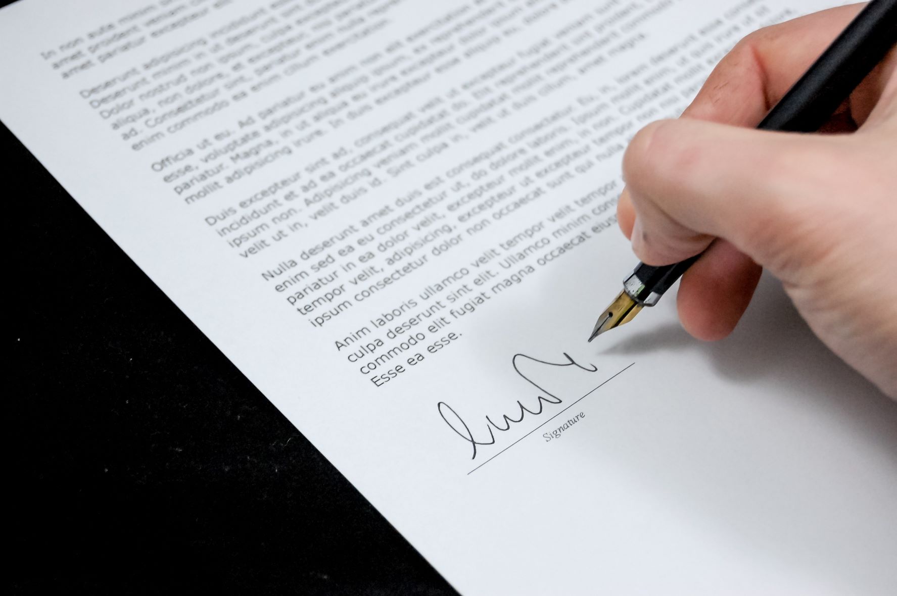 man signing payment plan agreement with HOA